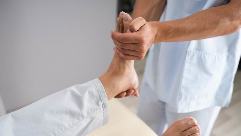 man getting hands-on therapy for ankle sprain