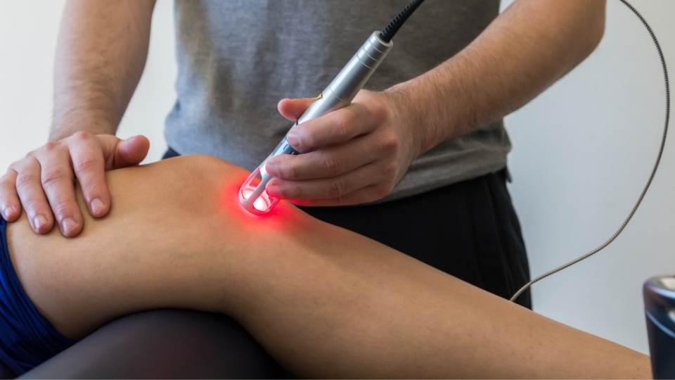 woman getting laser therapy for dublin physio & chiropactic