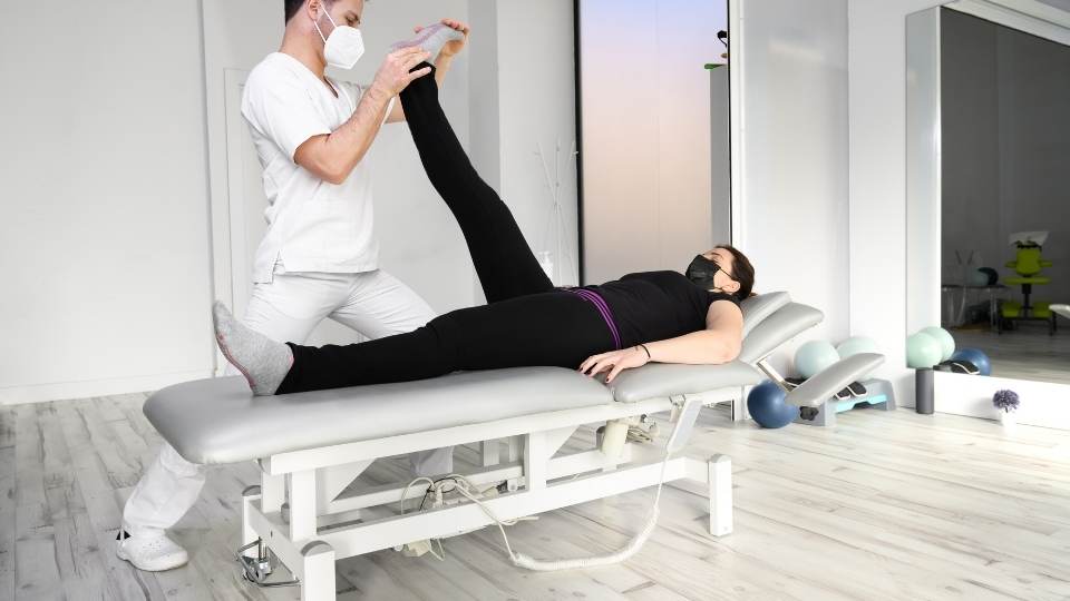 physiotherapist treating client with sciatic nerve pain