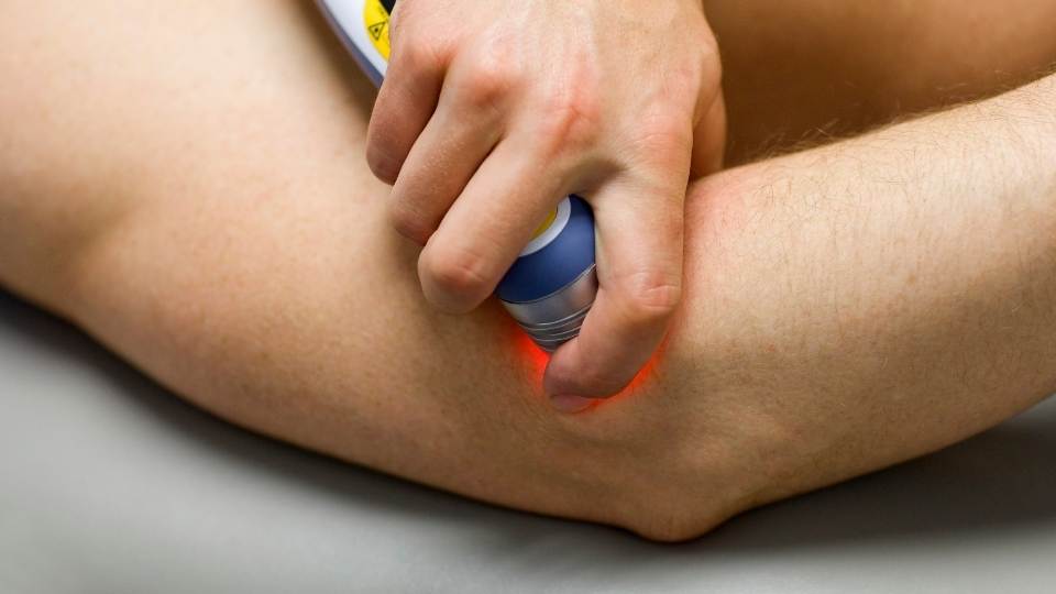 woman receiving laser therapy for cubital tunnel syndrome